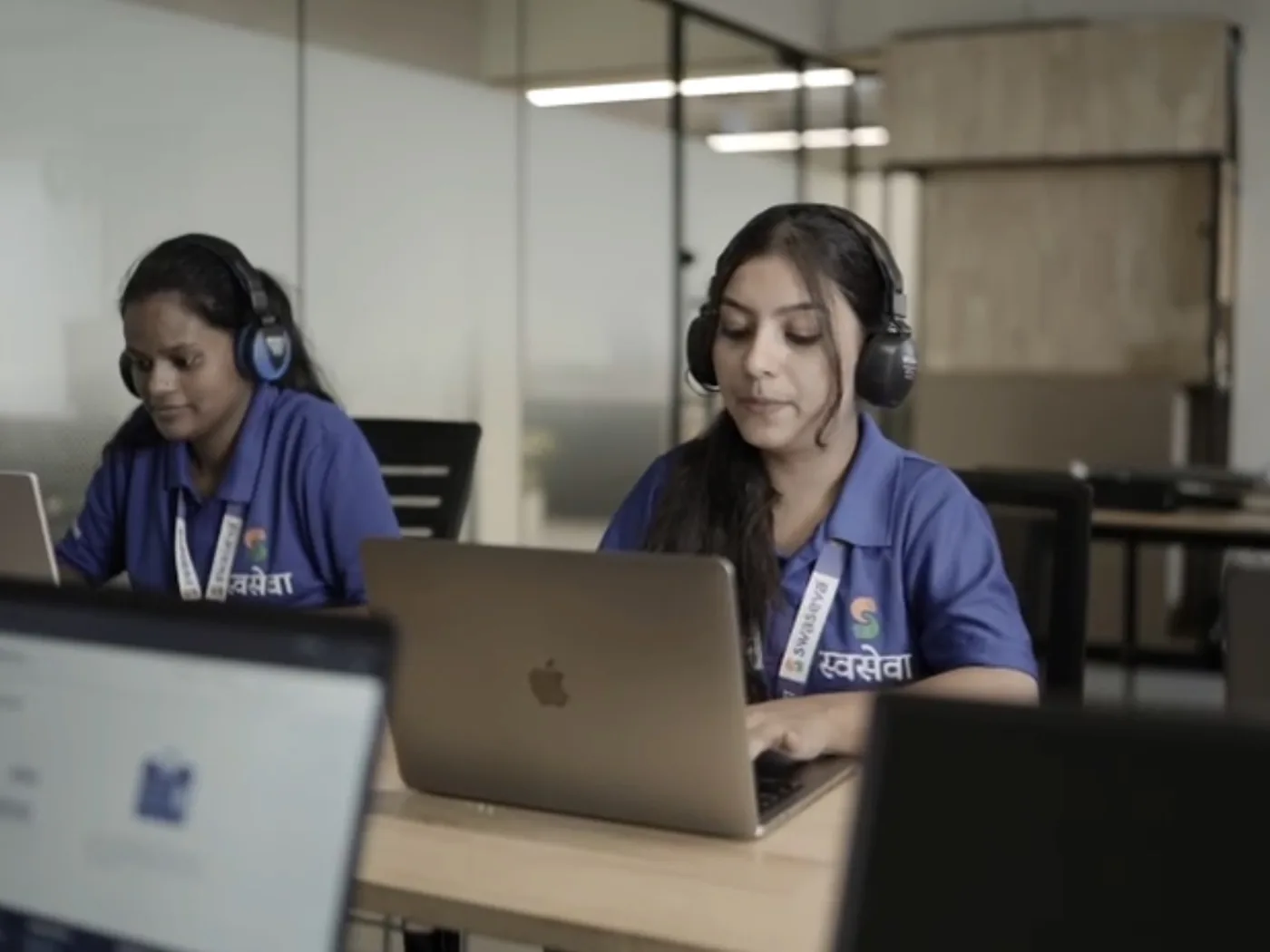 Swaseva support team on calls with headsets at their laptops