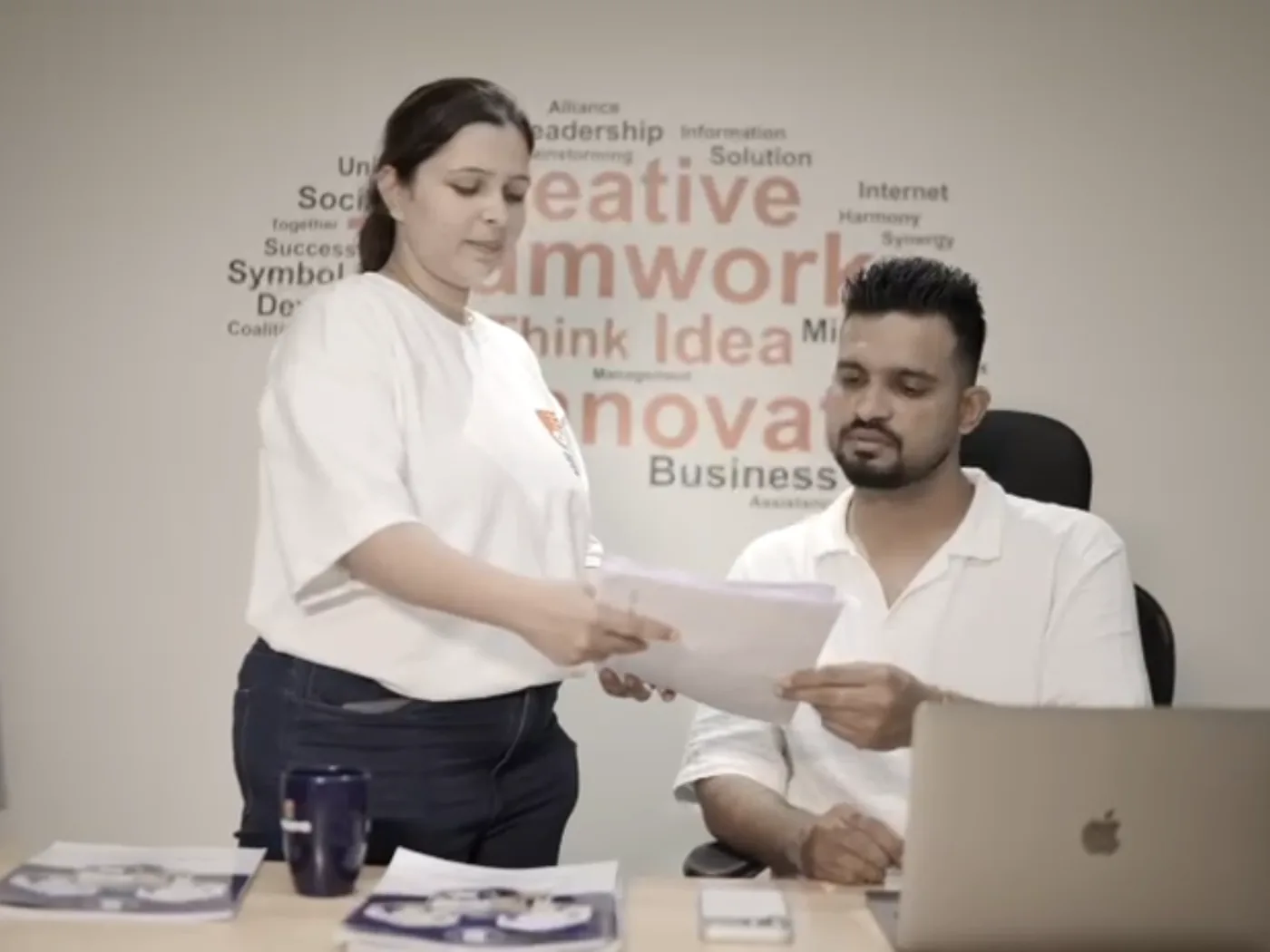 Swaseva founder reviewing papers with a team member at the office