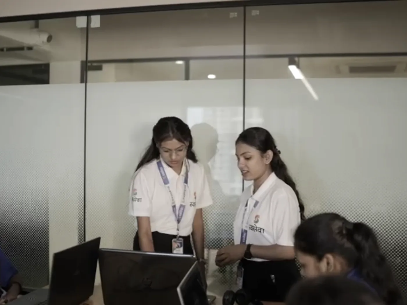 Swaseva staff going through documents together at a desk