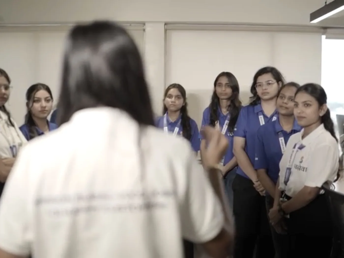 A Swaseva trainer addressing new team members in uniform